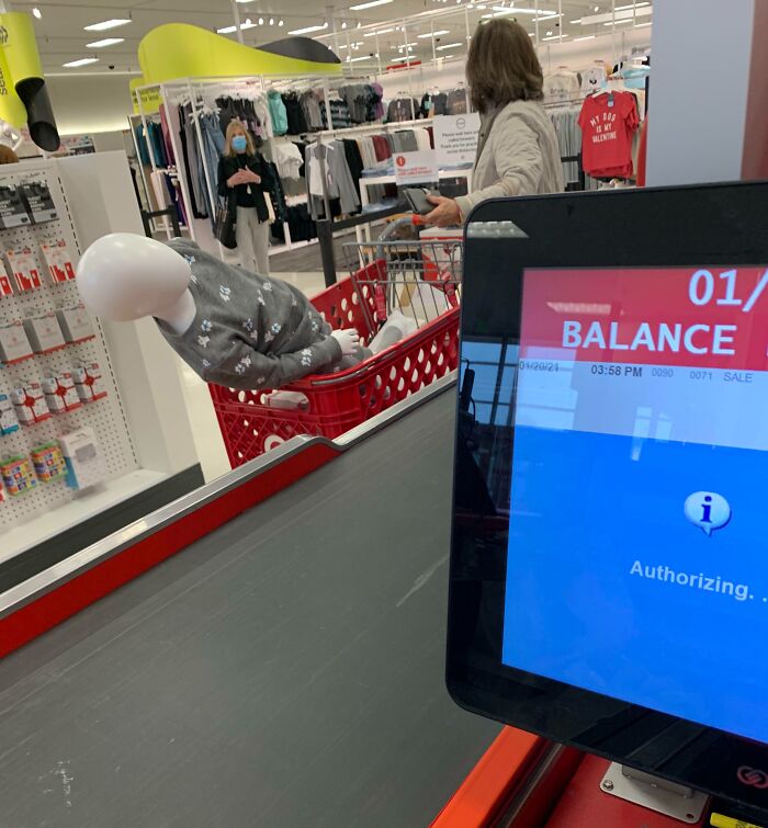 Shopping cart with mannequin at checkout, highlighting entitled Karens behavior in a retail store environment.