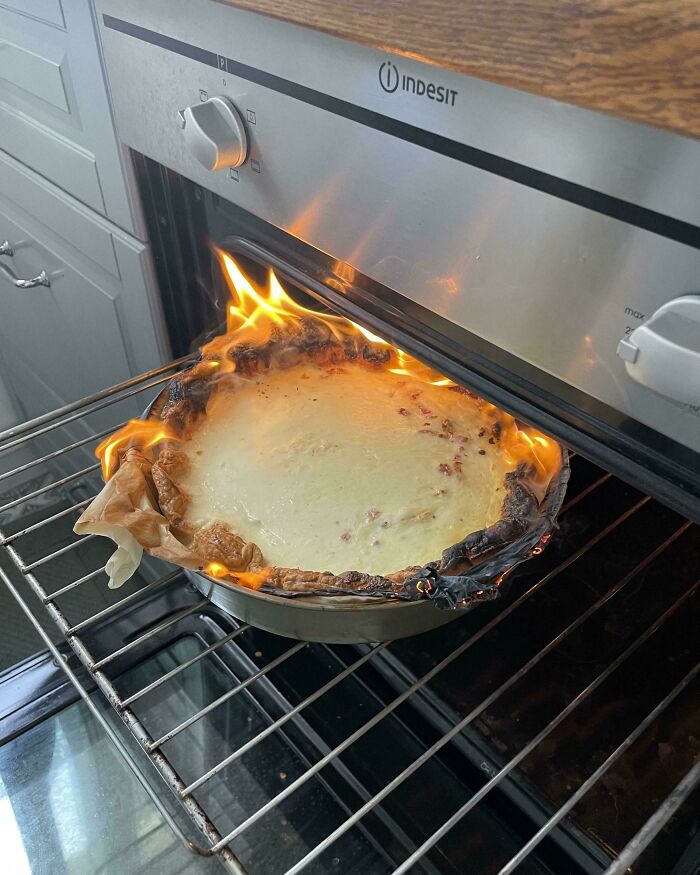 Baking disaster with pie crust on fire inside an oven, showing what could go wrong in cooking mishaps.