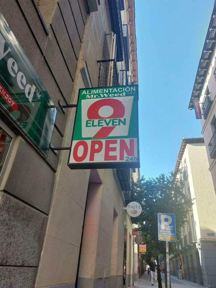 Sign mimicking famous brand 7-Eleven altered to 9-Eleven on a street, showcasing shameless designer copying.