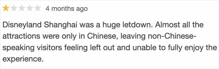 One-star customer review complaining about Disneyland Shanghai, highlighting issues with language barriers and visitor experience.