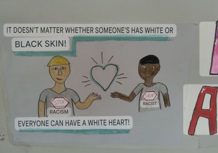 A drawing of two people with a white heart between them, with text about stopping racism and everyone having a white heart, a funny fail.