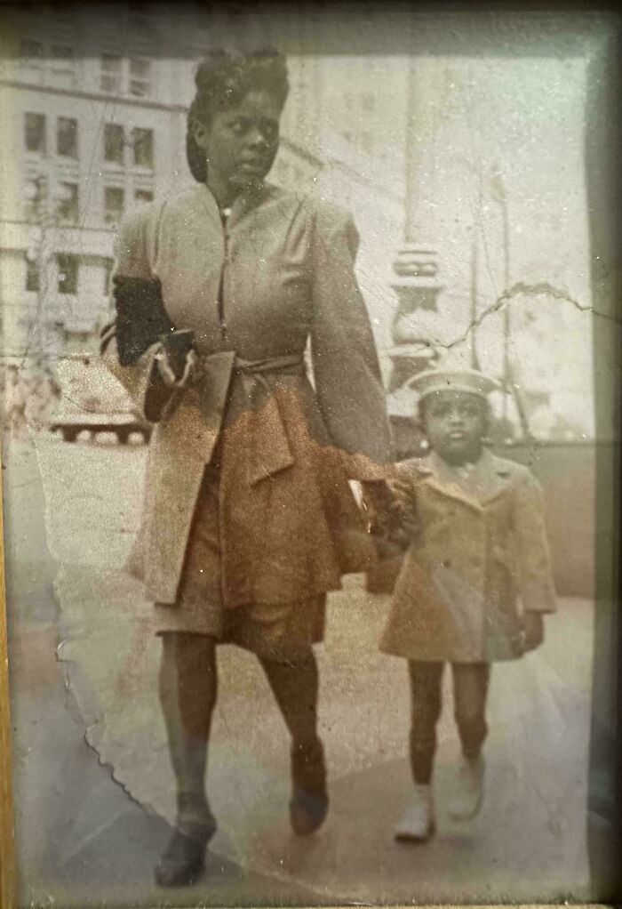 A candid old photo of a mother and child walking, showing what the world looked like generations ago.