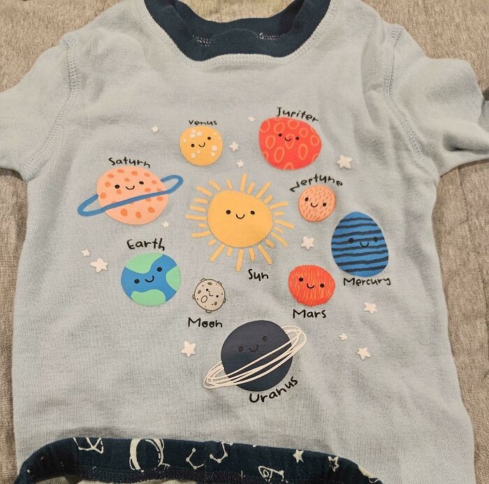 A baby's shirt with planets and a sun. A funny fail is that Uranus is written as 'Uranus' instead of 'Uranus'.