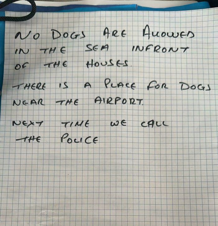 Handwritten note warning no dogs allowed by the sea near houses, reflecting neighbors that make you move to nowhere.