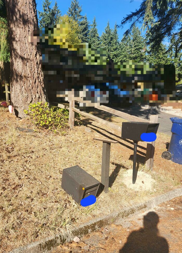 Damaged and knocked-over mailbox in a rural area representing neighbors that would make you move to the middle of nowhere.