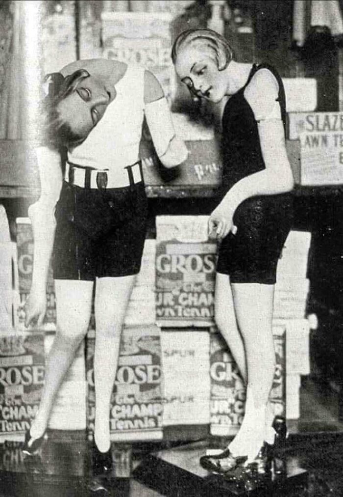 Vintage bizarre throwback moment showing two mannequins with unusual head positions in a store display.