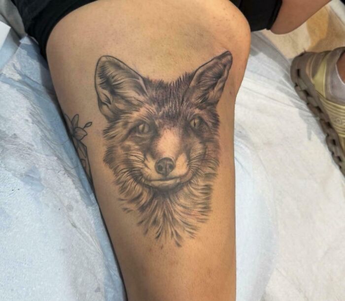 Realistic fox tattoo on thigh, showcasing detailed shading and fur texture in truly awful tattoos collection.