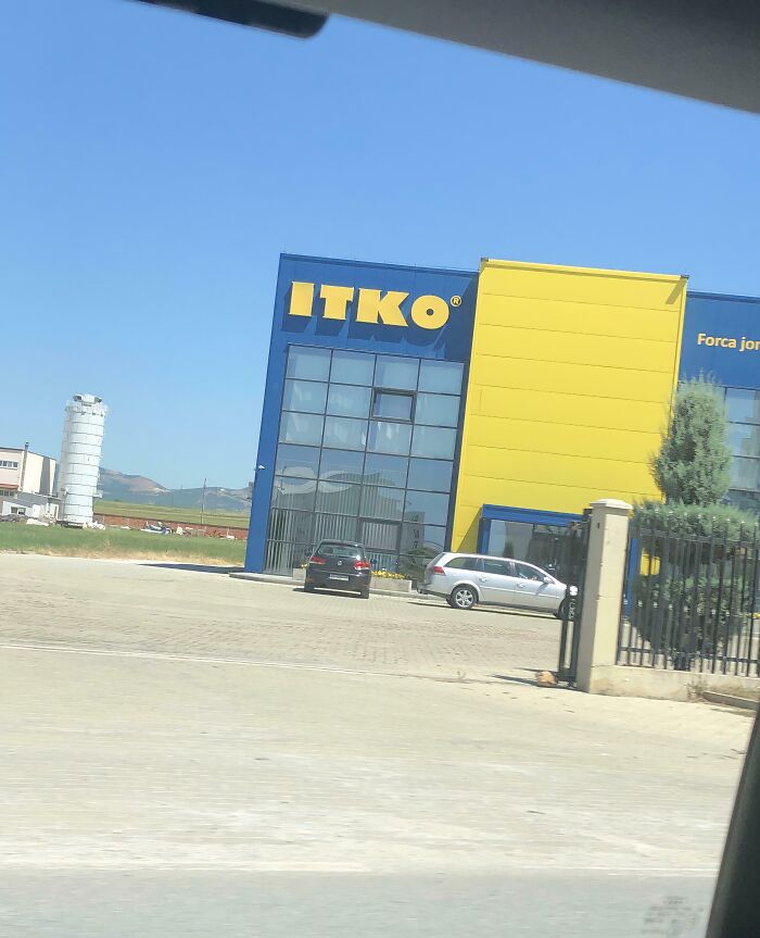 Building with a blue and yellow facade displaying the brand ITKO, showcasing shameless designer brand copying.