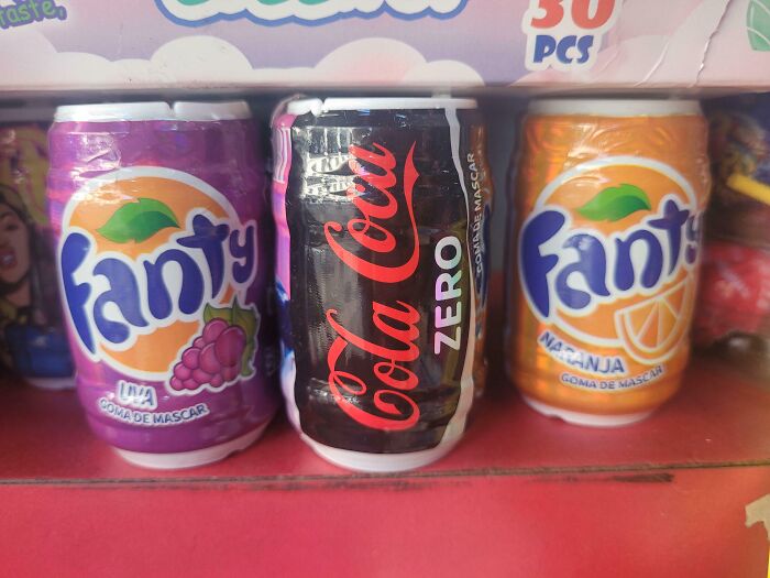 Three chewing gum cans imitating famous soda brands Fanta and Coca Cola Zero in a humorous copycat design.