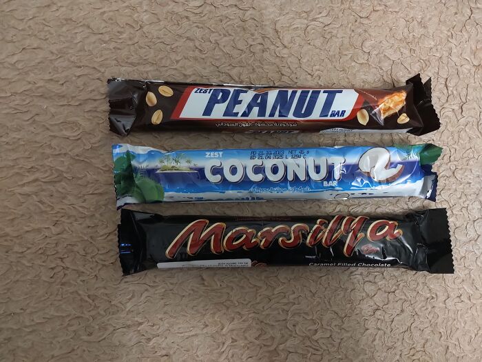 Three chocolate bars with packaging that shamelessly copies famous brand designs, highlighting designer imitation fails.