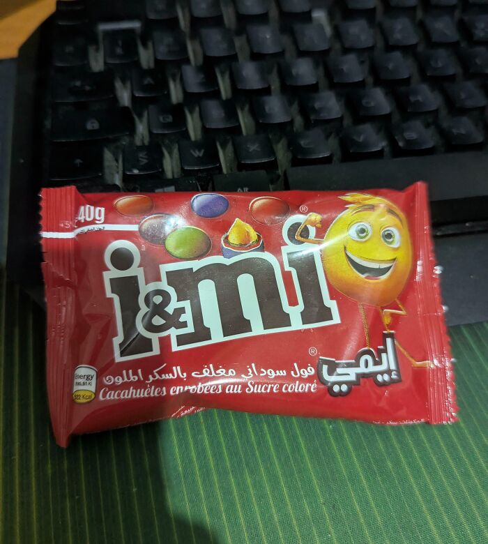 Snack packaging mimicking famous brand design with colorful candy-coated peanuts and a playful character.