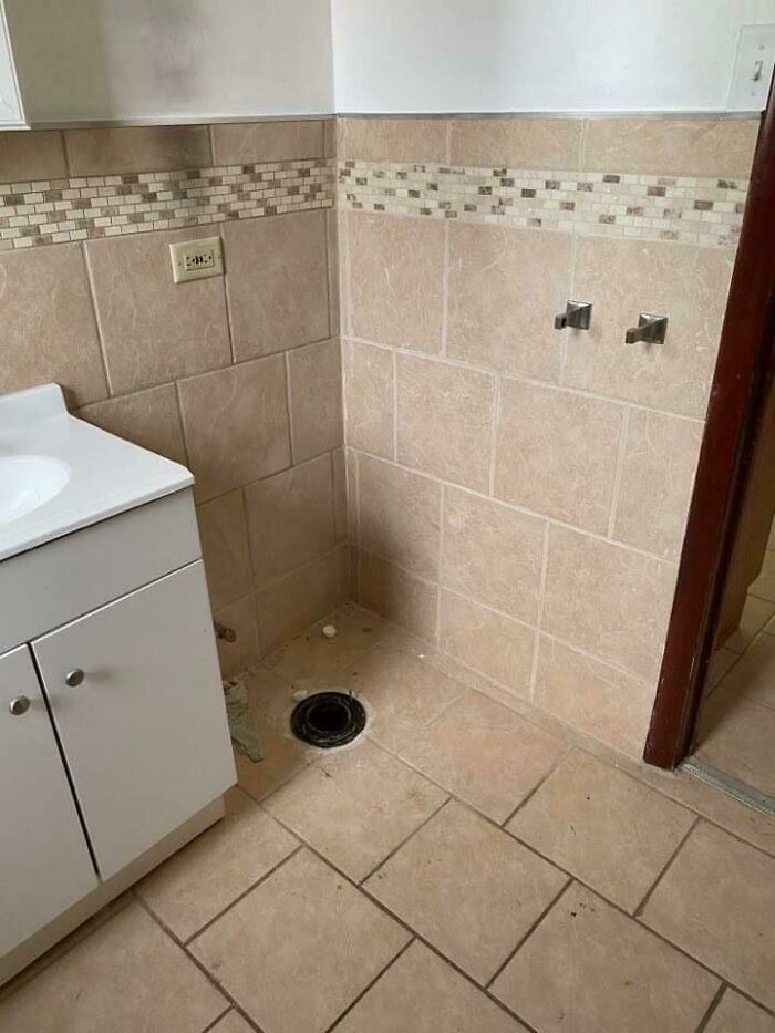 Bathroom corner with missing toilet plumbing showing a home buying regret and poor installation in the house.
