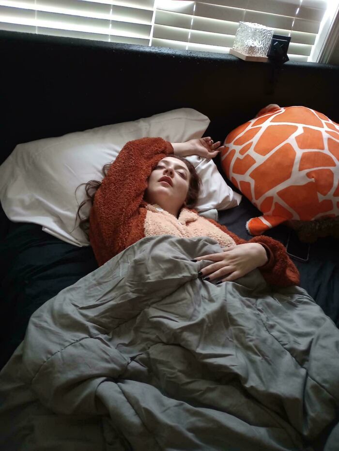 Woman sleeping in bed with an arm upraised, in the style of an Accidental Renaissance painting.