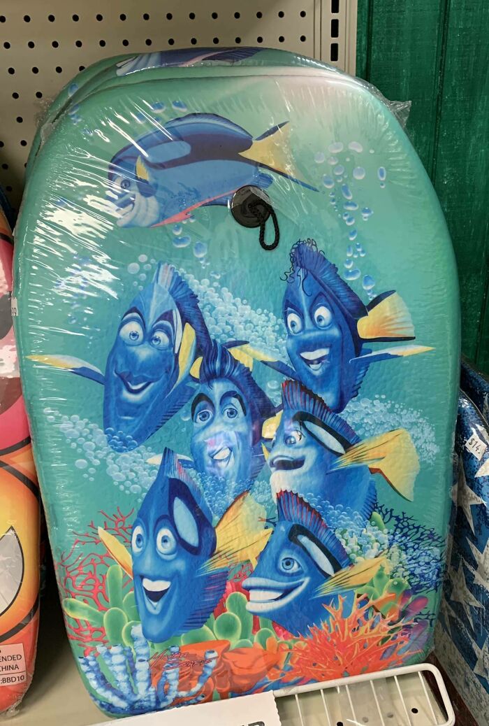 Hilariously shameless designer knockoff of famous animated fish characters on a colorful swim board in store display.