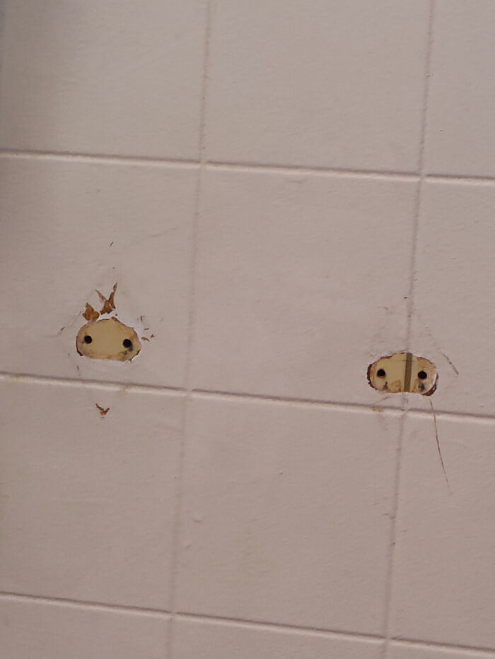 Wall tiles with visible damage and holes, showing issues often faced by people who bought homes and regretted it.