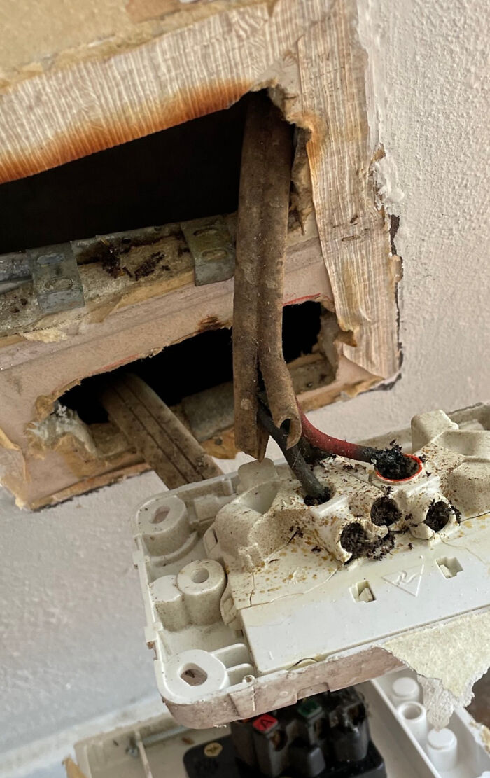 Old damaged electrical wiring inside a home wall showing potential hazards buyers regretted almost immediately.