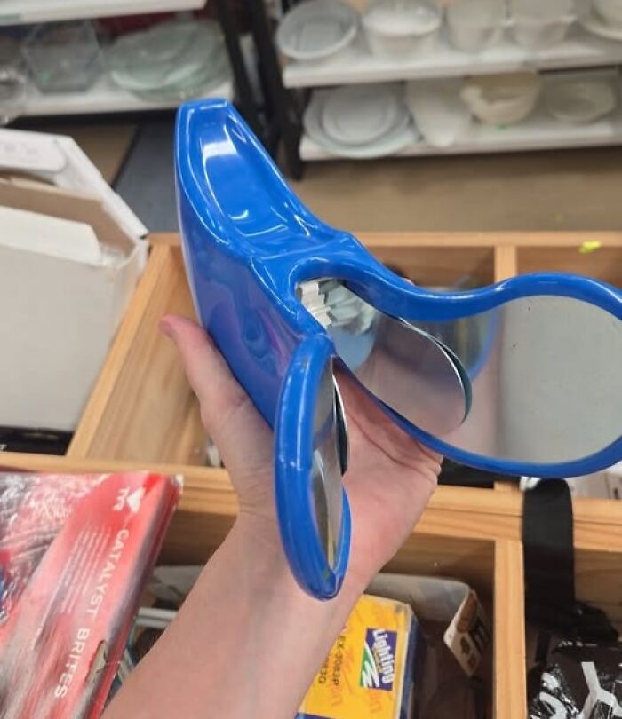 Blue plastic object with mirrored wings held in hand, an example of internet solving mystery of unidentified objects.