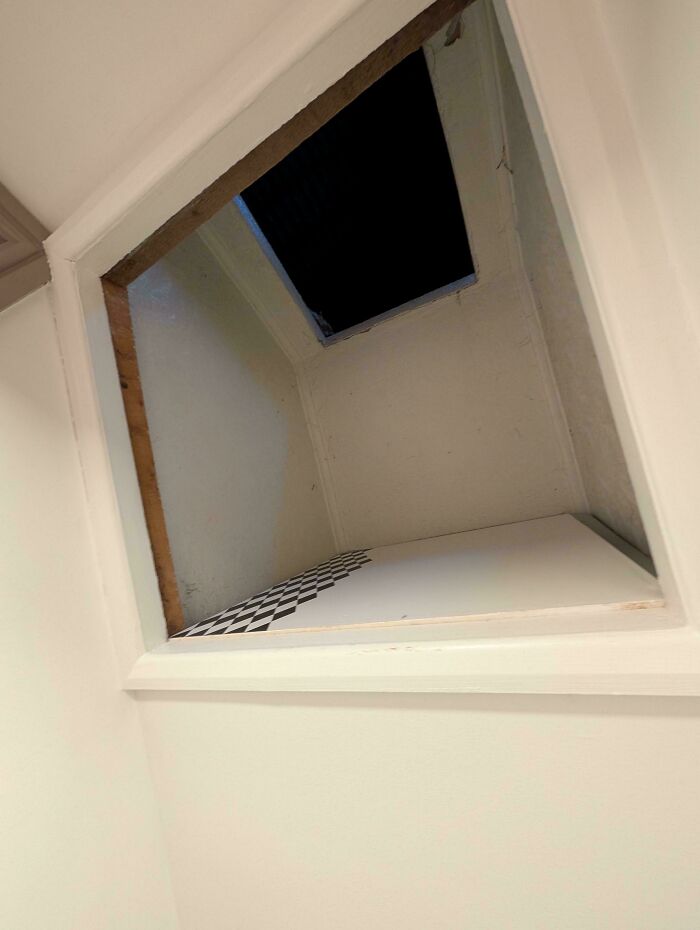 Open attic space with a checkerboard pattern floor inside, one of the weird and unexplainable images.