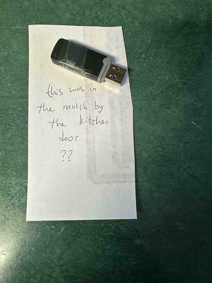 USB flash drive taped on a note saying it was found in mulch by kitchen door, one of the weird and unexplainable images.