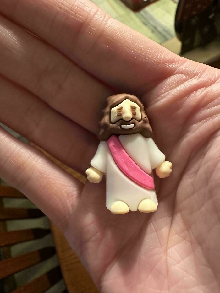Small figurine resembling a cartoonish character held in hand, one of the weird and unexplainable images.