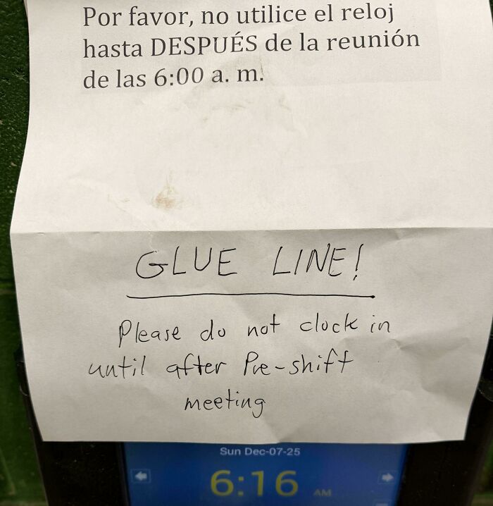 Handwritten and printed signs on a clock-in machine show workplace rules, highlighting modern work frustrations and raise concerns.