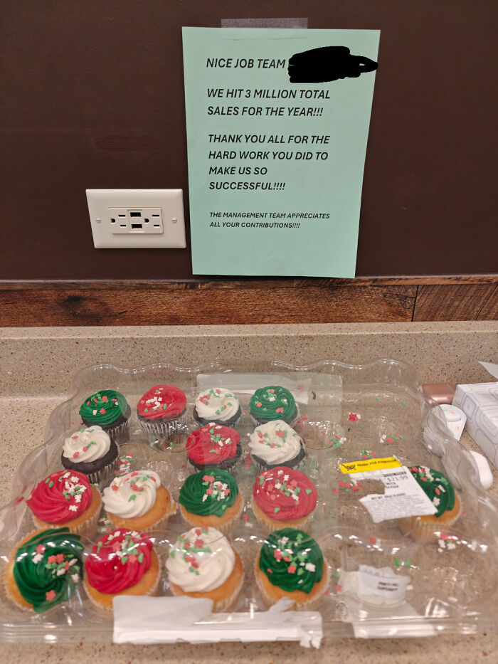 A half-empty box of cupcakes on a counter below a thank-you note, illustrating workplace appreciation and raise meaning.