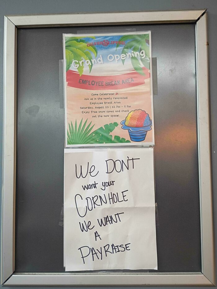 Employee break area grand opening sign with a handwritten note saying workers want a pay raise not cornhole.