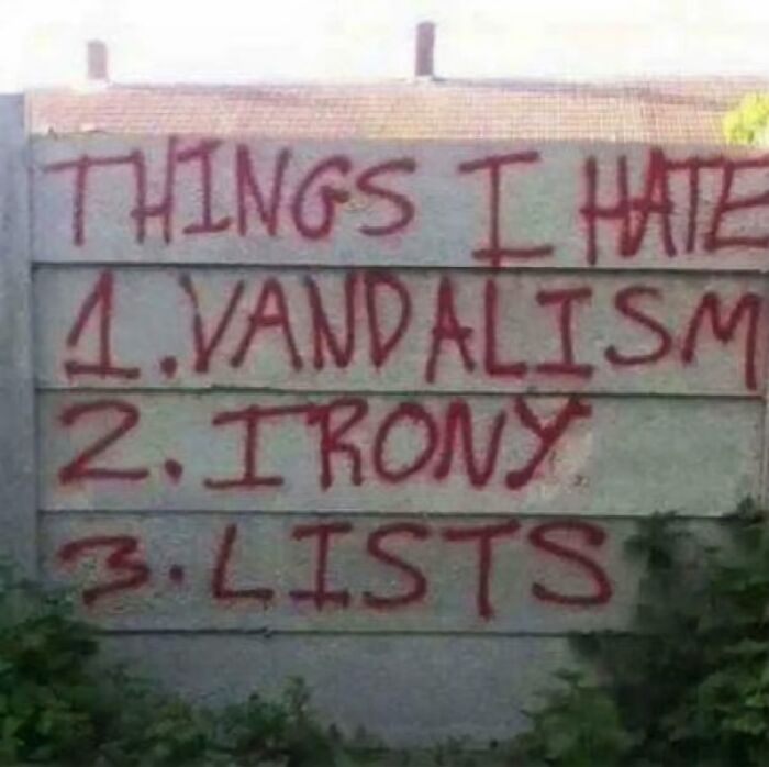 Graffiti on a wall listing things hated including vandalism, irony, and lists, showcasing sarcastic images with ironic humor.