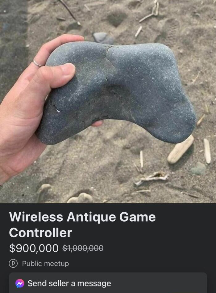 Hand holding a rock shaped like a game controller listed on Facebook Marketplace in unhinged pics requiring double takes.