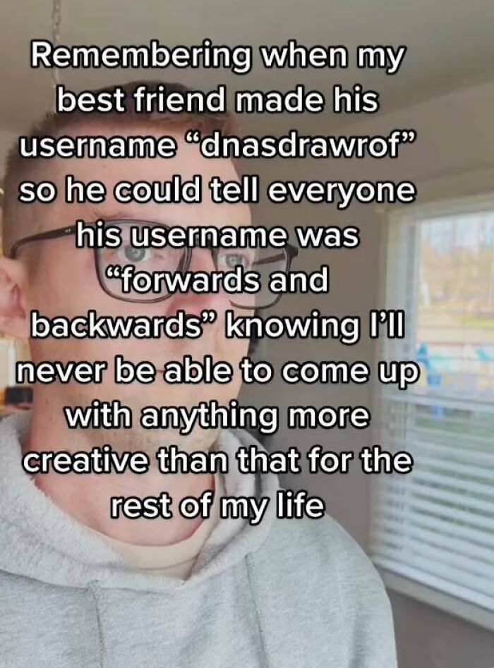 Person in glasses wearing a gray hoodie with a meme about creative usernames and entertaining memes.