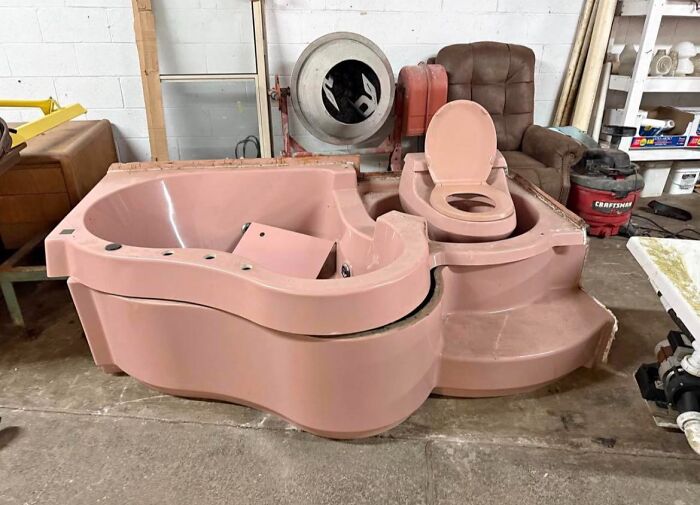 Unhinged Facebook Marketplace find shows a pink bathtub and toilet combination in a cluttered warehouse setting.