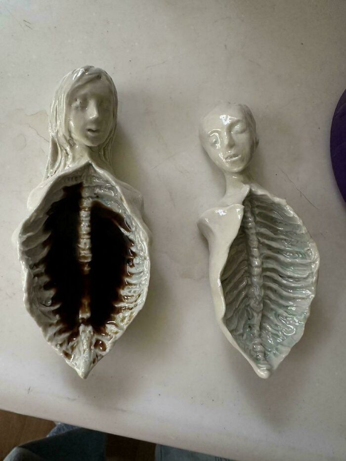 Two creepy ceramic busts, hollowed out with visible ribs and dark interiors, creating unsettling imagery of kids.