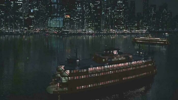 Two large illuminated ships on water at night with a city skyline in the background, showing nonsensical movie details.