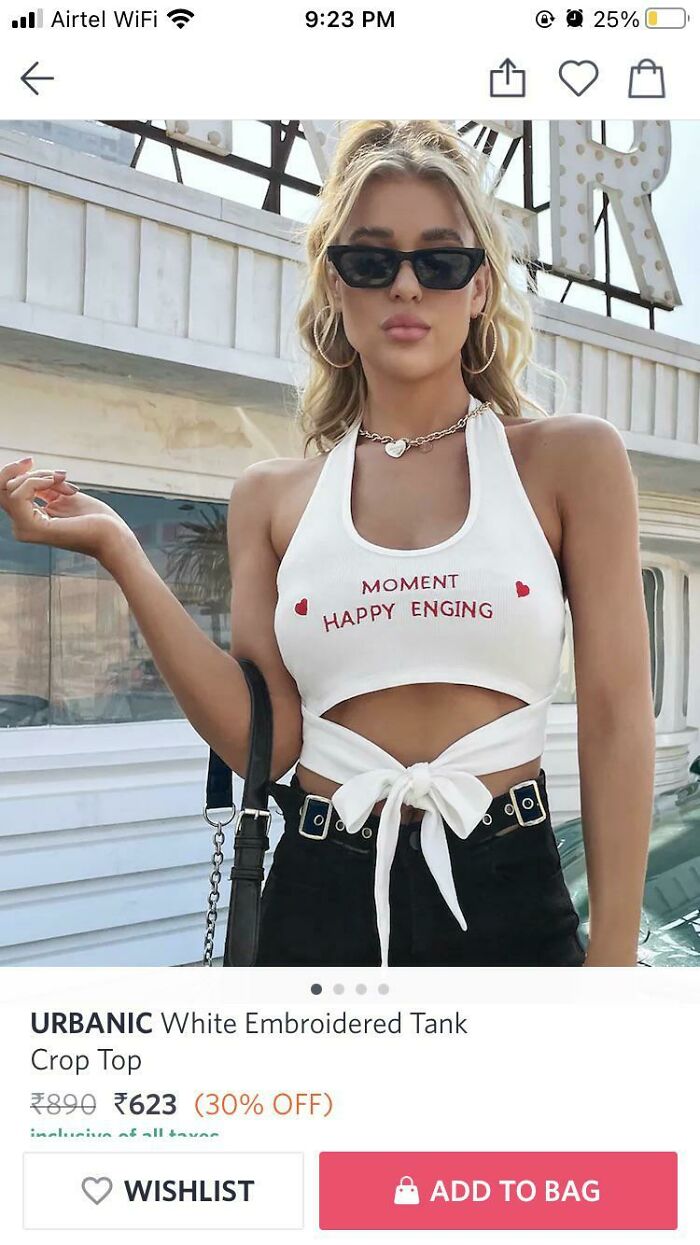 Woman wearing a white tank crop top with a misspelled phrase, showcasing a hilariously bad t-shirt design.