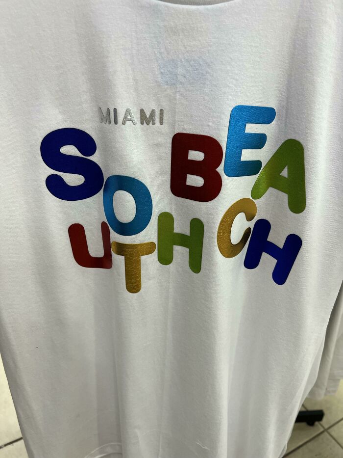 White t-shirt with a colorful and confusing South Beach design, showcasing hilariously bad t-shirt designs.