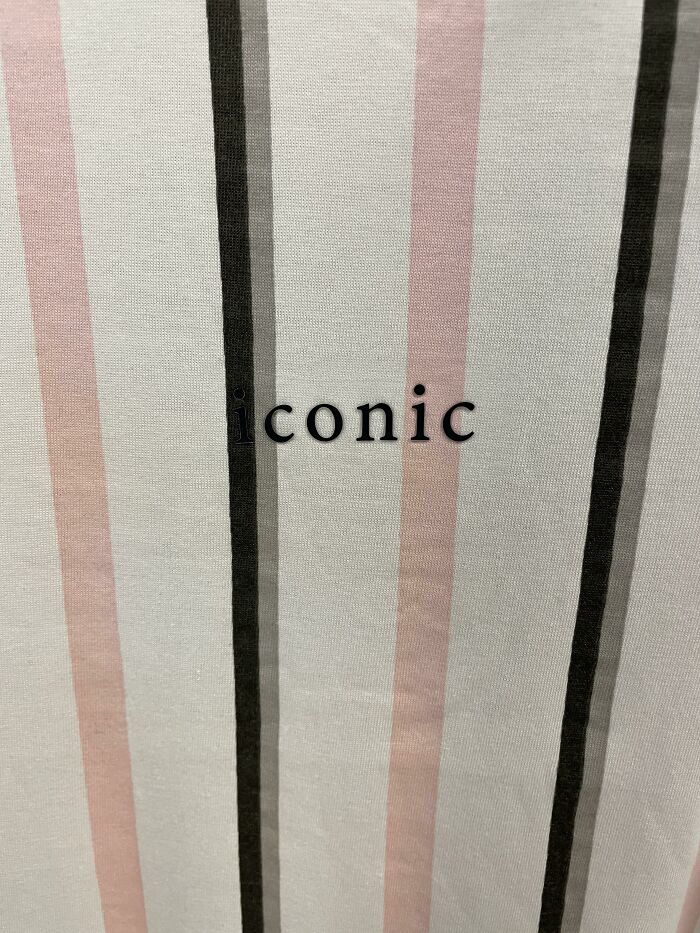 Close-up of a striped t-shirt with the word iconic printed, illustrating hilariously bad t-shirt designs.