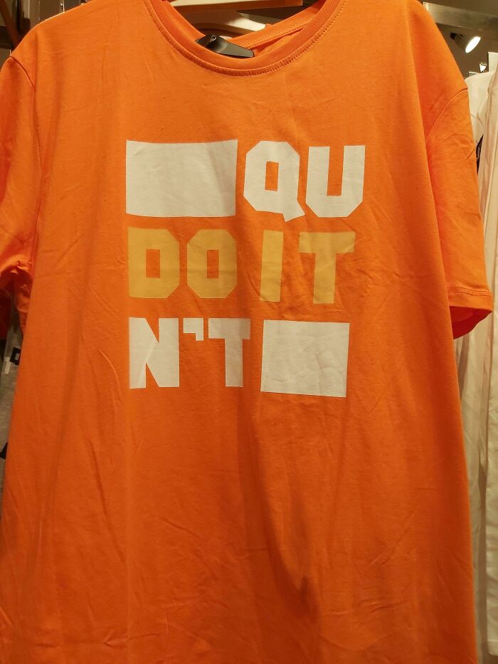 Orange t-shirt with a hilariously bad design featuring incomplete text and missing letters on front.