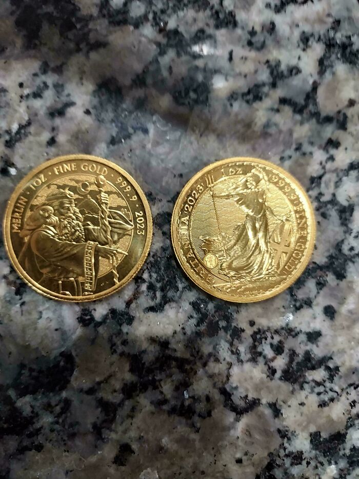 Two detailed gold coins resting on a granite surface, showcasing fine craftsmanship and intricate designs for collectors.