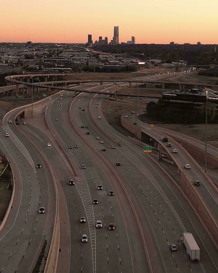 Urban hell highway interchange with few vehicles at sunset