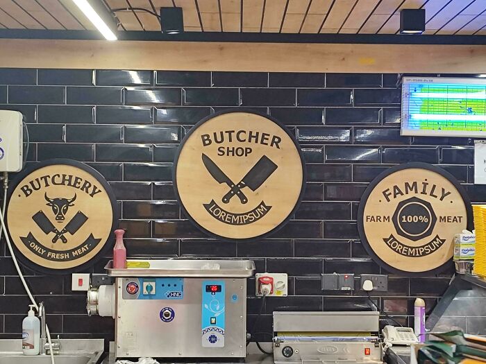 Three signs in a butcher shop, all with the placeholder text Lorem Ipsum, a funny job fail.