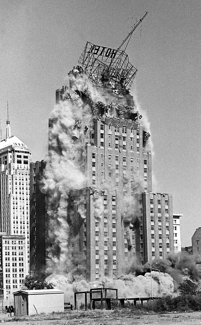 Black and white urban hell building demolition with smoke and debris
