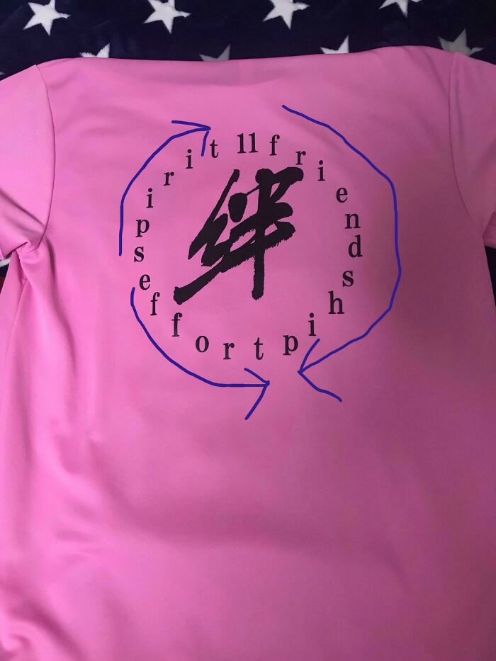Pink t-shirt with confusing and misspelled design featuring the words friendship and support in a circular pattern.