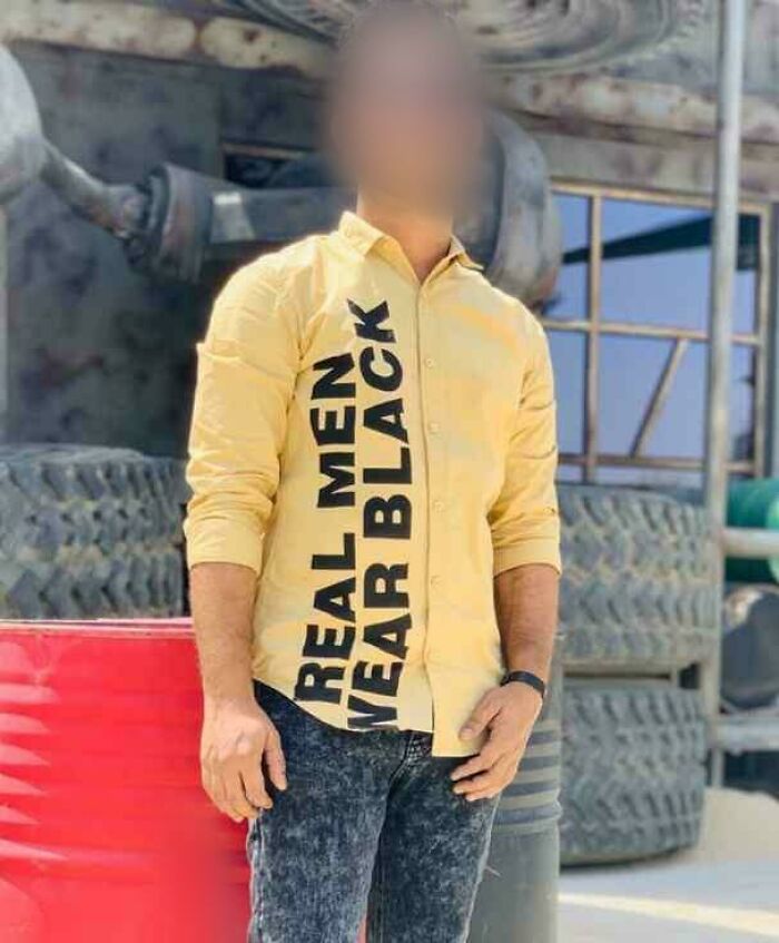 Man wearing yellow shirt with large black text design, an example of hilariously bad T-shirt designs outdoors