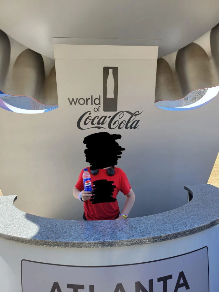 Person holding a Pepsi bottle at the World of Coca-Cola, highlighting first-world anarchists challenging norms.