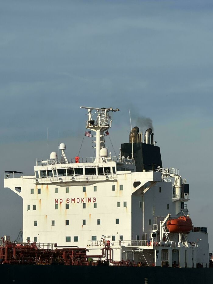 Large cargo ship with visible smoke stacks and no smoking sign, symbolizing ungovernable first-world anarchists.
