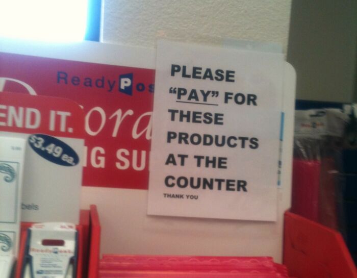 Sign with suspicious use of quotation marks around the word pay, creating a humorous effect in a store setting.