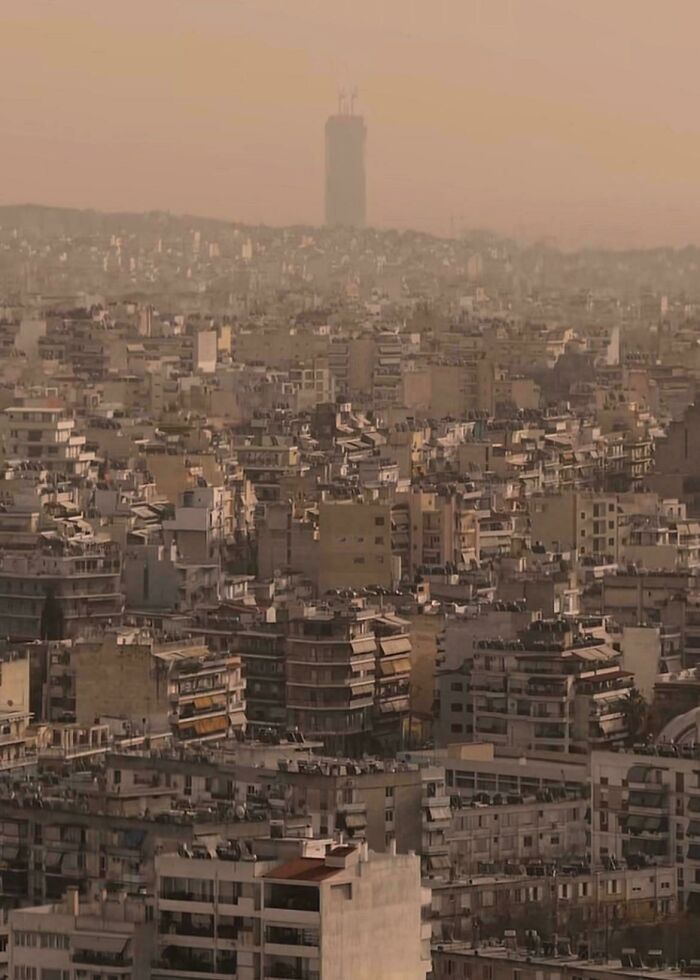 Dense urban hell cityscape with hazy sky and crowded buildings