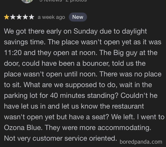 One-star absurd customer review complaining about restaurant opening times and poor service experience.