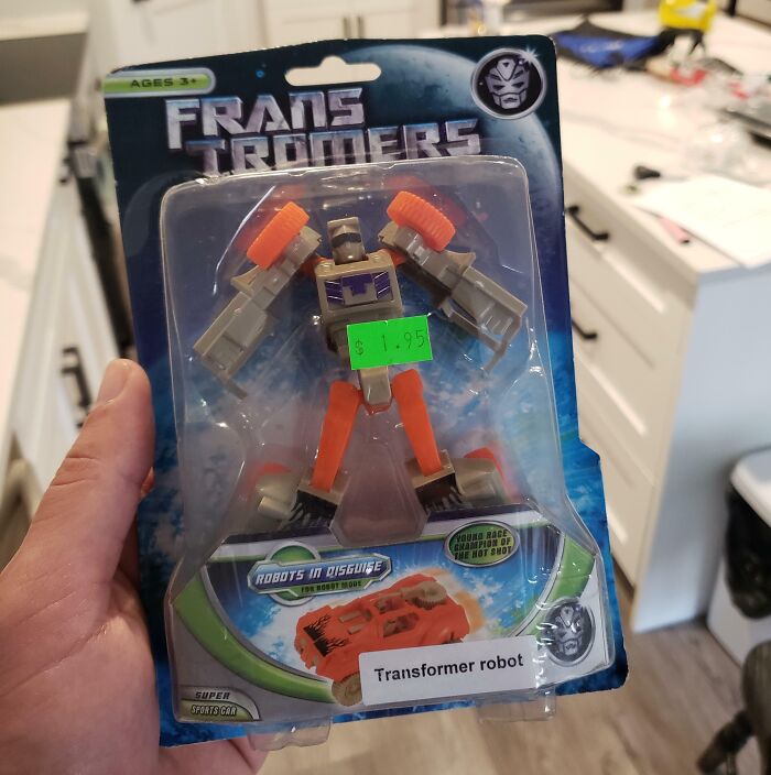 Frans Trommers toy packaging featuring a knockoff Transformer robot with orange and gray colors.