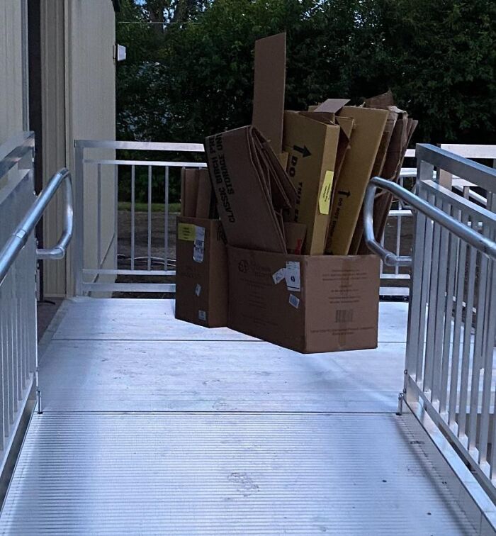 Stack of cardboard boxes seemingly floating above a ramp, a mind-bending photo that might mess with your brain.